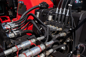 Hydraulic system components with intricate hoses and fittings showcased in a close-up view, highlighting engineering precision and mechanical design