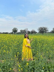 Fototapeta premium Woman in traditional attire in green field
