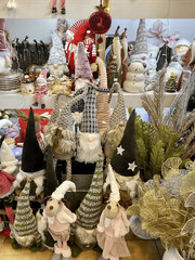 Festive Christmas gnome dolls and holiday decorations on display in a store during winter season