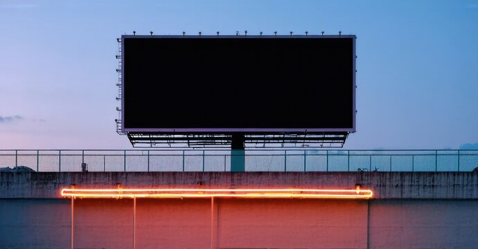 Billboard stands atop concrete structure. Sky displays pastel hues, contrasting with bright orange neon light below blank sign. Minimalist composition.