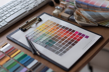 Creative workspace with color palette samples, swatches, and keyboard. Ideal for interior, fashion, or graphic design projects. Copy space included.