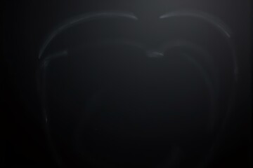 Abstract dark image, reminiscent of charcoal sketch, depicting a shadowy, ambiguous form.  Suitable for mystery, suspense, or contemplative themes.