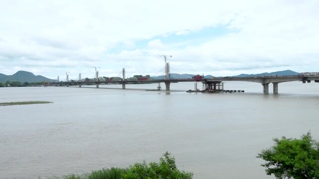 Modern Cable-Stayed Bridge Under Construction Over Wide River &ndash; 4K
