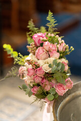 Wedding bouquet featuring pink and white roses, greenery and delicate accents arranged beautifully for a special occasion