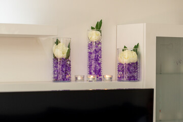 Elegant floral arrangement with white roses and purple gel beads enhances modern home décor