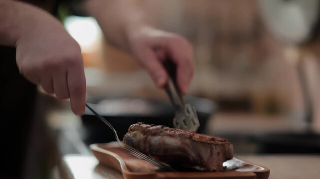 A man plates a freshly seared Osso Buco steak, with steam rising from the hot meat. Spices and herbs are blurred in the background. Gourmet cooking at home