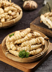 Freshly dug ground silkworms served with pagoda cabbage and stoneworms in a rustic setting