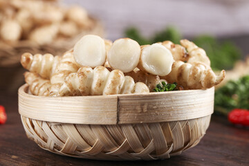 Fresh screw greens served in a woven basket alongside ground bullock in a rustic kitchen setting