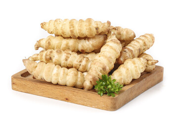 Freshly harvested ganja green roots displayed on a wooden board showcasing local produce