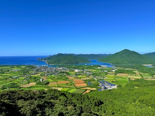 Scenic view from Jodake Observatory, Fukue Island, Goto Islands, Nagasaki, Japan – terraced farmland, island-dotted coastlines, and rich green hills with blue sky and sea.