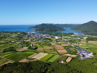 Scenic view from Jodake Observatory, Fukue Island, Goto Islands, Nagasaki, Japan – terraced farmland, island-dotted coastlines, and rich green hills with blue sky and sea.