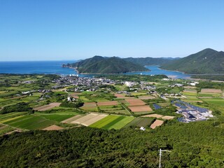 Scenic view from Jodake Observatory, Fukue Island, Goto Islands, Nagasaki, Japan – terraced farmland, island-dotted coastlines, and rich green hills with blue sky and sea.