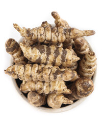 Freshly harvested Manihot Esculenta roots displayed in a rustic bowl for a nutritious and hearty meal preparation