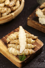 Fresh ground silkworm grass cabbage displayed on wooden plates showcasing unique textures and natural colors