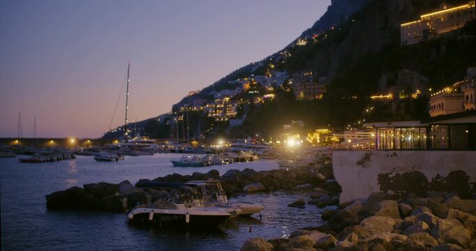 Waves blue water pebbles tide rocks sea Italy Amalfi coast boats 