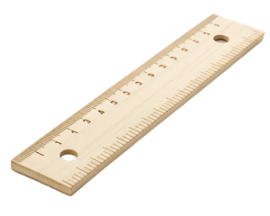 Close up of a wooden ruler with markings and holes on a dark background in a diagonal position