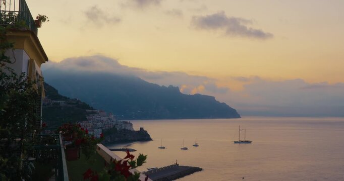 Waves blue water pebbles tide rocks sea Italy Amalfi coast boats 