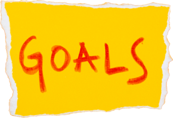Yellow paper with handwritten goals message in red ink for motivation and planning in personal development or business strategy
