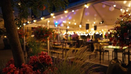 Experience a charming outdoor evening event complete with beautiful lights and exquisite floral decor