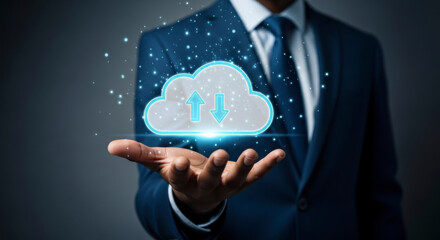 Businessman in a suit holding a glowing cloud computing icon with up and down arrows representing data transfer and digital storage