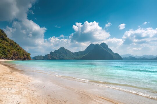 Beautiful beach with turquoise water and tropical mountains in the background