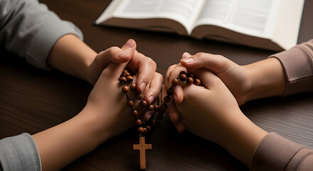 Two hands clasped in prayer holding rosary beads