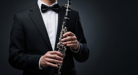 Elegant musician in a classic tuxedo holds a clarinet showcasing a refined portrait of artistry and musical skill