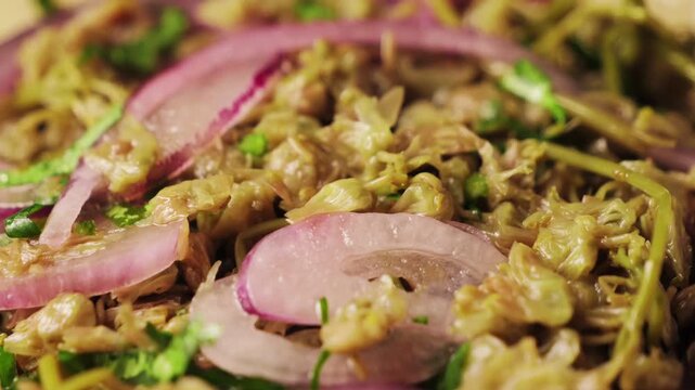 Traditional Georgian pickled. Pickled Dzhondzholi young shoots of the caper bush with flowers, drizzled with vegetable oil, sprinkled with chopped green or onion. High quality 4k footage