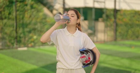 Indian gen z athlete sports teen age girl woman standing outdoor play ground wear white uniform hold protective helmet and hand gloves Asian cricket player female take break time drink water at match	 - Powered by Adobe