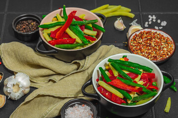 Vibrant frozen vegetable mix with yellow and green beans, red bell peppers, corn. Frosty texture