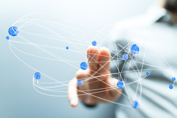 Abstract image of a hand interacting with a digital network, representing global connection and communication.