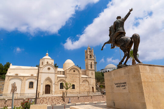 Dipkarpaz, Karpas Peninsula, Northern Cyprus - July 14, 2025: Statue of Ataturk on a horse and  old orthodox Ayios Synesios Church in the background