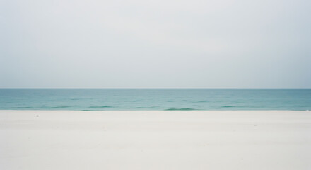 Fototapeta premium Serene White Sand Beach and Calm Blue Sea Horizon