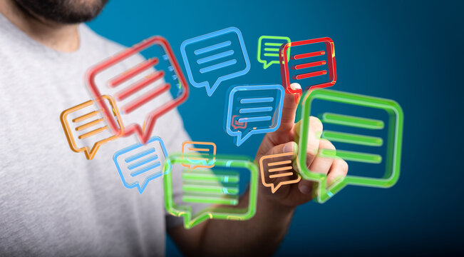 Person touching holographic chat bubbles,communication, messaging, digital concept.