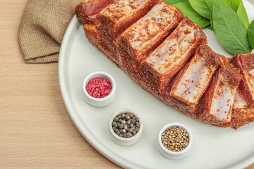 Marinated raw ribs with spices and herbs. Traditional ingredient for BBQ, picnic concept