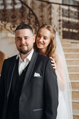 The bride and groom are on a beautiful staircase.