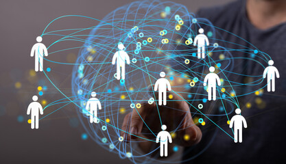 Stock photo of a hand interacting with a digital network of people, representing global connectivity and teamwork.