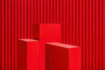 Three vibrant red geometric pedestals of varying heights against a textured red background, ideal for product showcases