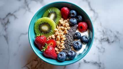 Vibrant breakfast bowl with granola, Greek yogurt, kiwi, blueberries, chia seeds, top view, colorful and healthy morning meal.