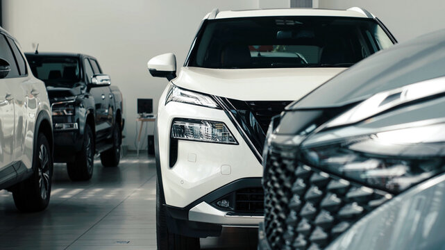 Modern car showroom featuring sleek vehicles in a well-lit space, showcasing automotive design and innovation for potential buyers