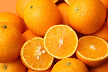 Fresh cut and whole oranges as background, top view
