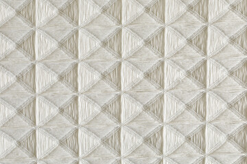 Obraz premium High-resolution image of beige fabric with a textured diamond pattern. Perfect for textile, background, and design proje