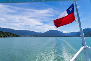 Chilean flag waving on ferry through patagonia fjords