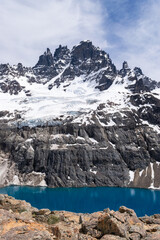 Turquoise lake reflecting snowy peaks in chile's patagonia region
