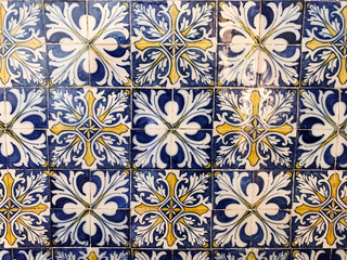 Close-up of traditional blue, yellow, and white patterned tiles with a Mediterranean aesthetic, captured in Cape Verde, showcasing intricate design and cultural flair.