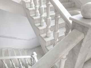 White staircase with marble balusters. Old fashioned marble staircase with balustrade