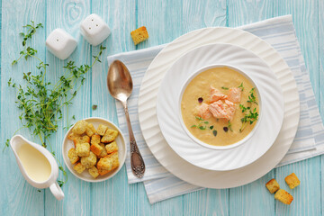 creamy salmon soup with herb in a bowl