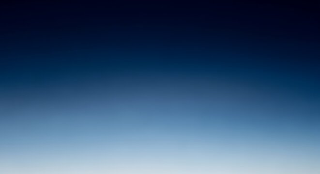Blue gradient sky background with smooth transition from light to dark