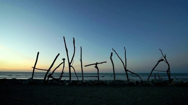 Hakuna matata written with driftwood on the beach during sunset