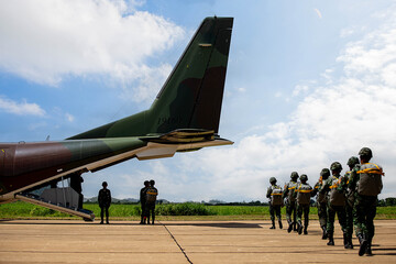 Formation Before Boarding, Paratroopers standing in organized formation on an airfield, preparing to board for an airborne mission.